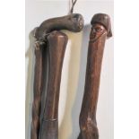 A collection  of walking sticks to include Tribal Africal carved example with figural mask head to
