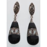 A pair of silver and marcasite art deco style teardrop earrings having pierced decoration with black