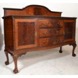 A large Edwardian mahogany serpentine fronted sideboard dresser being raised on cabriole legs with
