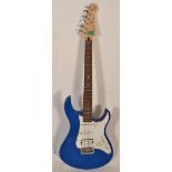 A Yamaha Pacifica stratocaster style electric guitar having a blue painted body with a white