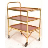 A retro 1950's three tier gilded metal butlers serving table trolley raised on the original