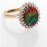 A hallmarked 14ct gold ammolite and diamond cluster ring. Hallmarked Birmingham. Weight 4g. Size Q.