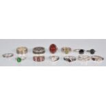 A group of 13 silver rings to include a red stone cabochon ring, a pearl ring in a cross over