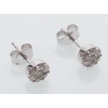 A pair of 18ct white gold stud earrings inset with a cluster of round cut diamonds. Diamonds