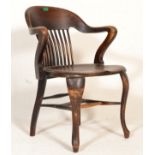 An early 20th Century oak Industrial office chair / desk armchair having shaped backrest termaning