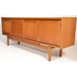 A mid century Danish inspired teak wood sideboard / credenza being raised on shaped legs with a wide