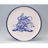A large early 20th Century English blue and white charger plate in the manor of Frederick Rhead