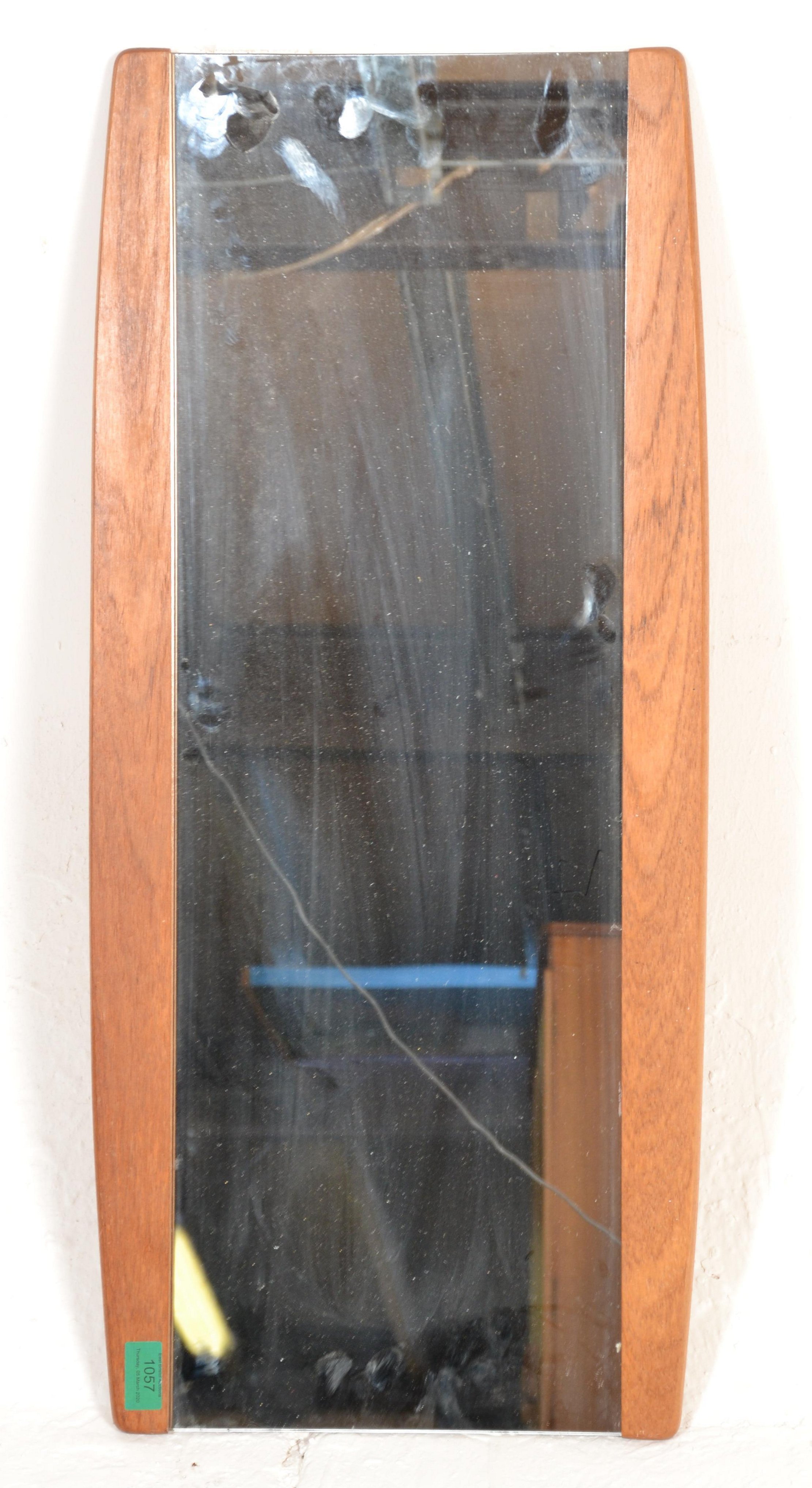 A retro mid century 1970's teak wood angular wall mirror of space age form. The lozenge shaped