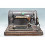 A 19th Century Victorian Bradbury's Soeze sewing machine having a black ground with gilt detailing
