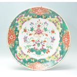 A large 19th Century Chinese wall charger plate for the South East Asian market having hand