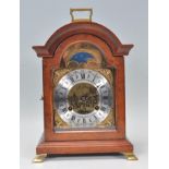 A contemporary bracket clock having a brass face with silver chapter ring having Roman numeral. Face