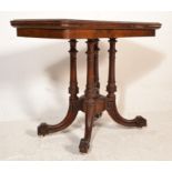 A VIctorian 19th century walnut Aesthetic movement card / games table being raised on a quatrefoil