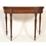 A George III  19th century mahogany tea / card games table being raised on reeded and tapering