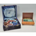 A mixed collection of vintage and later costume jewellery stored within a blue velvet box. Jewellery