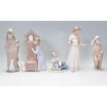 A collection of Nao porcelain figurines to include children playing with hobby horse, child with
