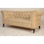 A Victorian 19th century mahogany Chesterfield drop arm sofa - settee. Raised on castors with turned