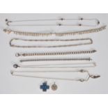 A selection of silver jewellery to include a flat link bracelet chain, a faceted link tennis