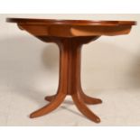 A retro mid century Nathan teak wood circular pedestal dining table. The extending circular top
