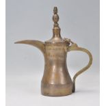 A 19th Century Islamic, believed Turkish brass Dallah teapot coffee pot having tall thin spout