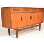 A mid century G-Plan teak wood Fresco pattern sideboard credenza having a series of cupboards