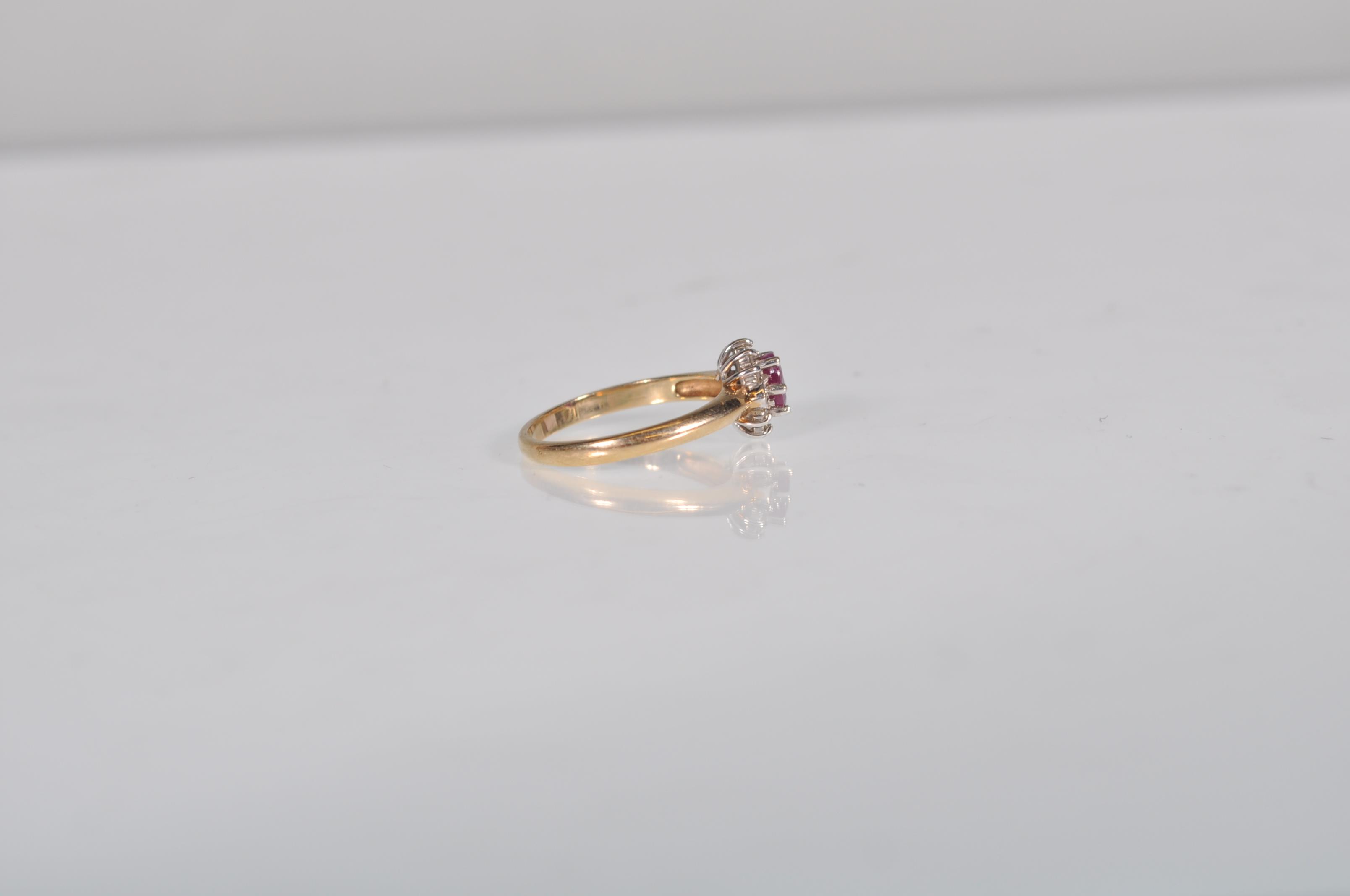 A hallmarked 9ct gold diamond and garnet flower head ring having a central faceted red stone with - Image 3 of 6