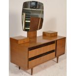 A vintage retro 20th Century oak Meredew dressing table raised on tapering supports with a series of
