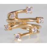 An English hallmarked 9ct yellow gold ring having a decorative split mount set with white stones.