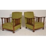 A pair of early 20th century barley twist oak armchairs. Raised on pad feet with barley twist legs