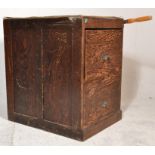 An early 20th century Industrial / school office filing cabinet raised on a plinth base with twin