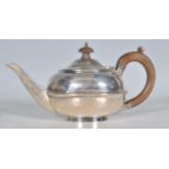 An early 20th Century silver hallmarked teapot of squat globular form with banded center and