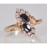 An English hallmarked 9ct yellow gold ladies dress ring having two offset faceted cut oval blue