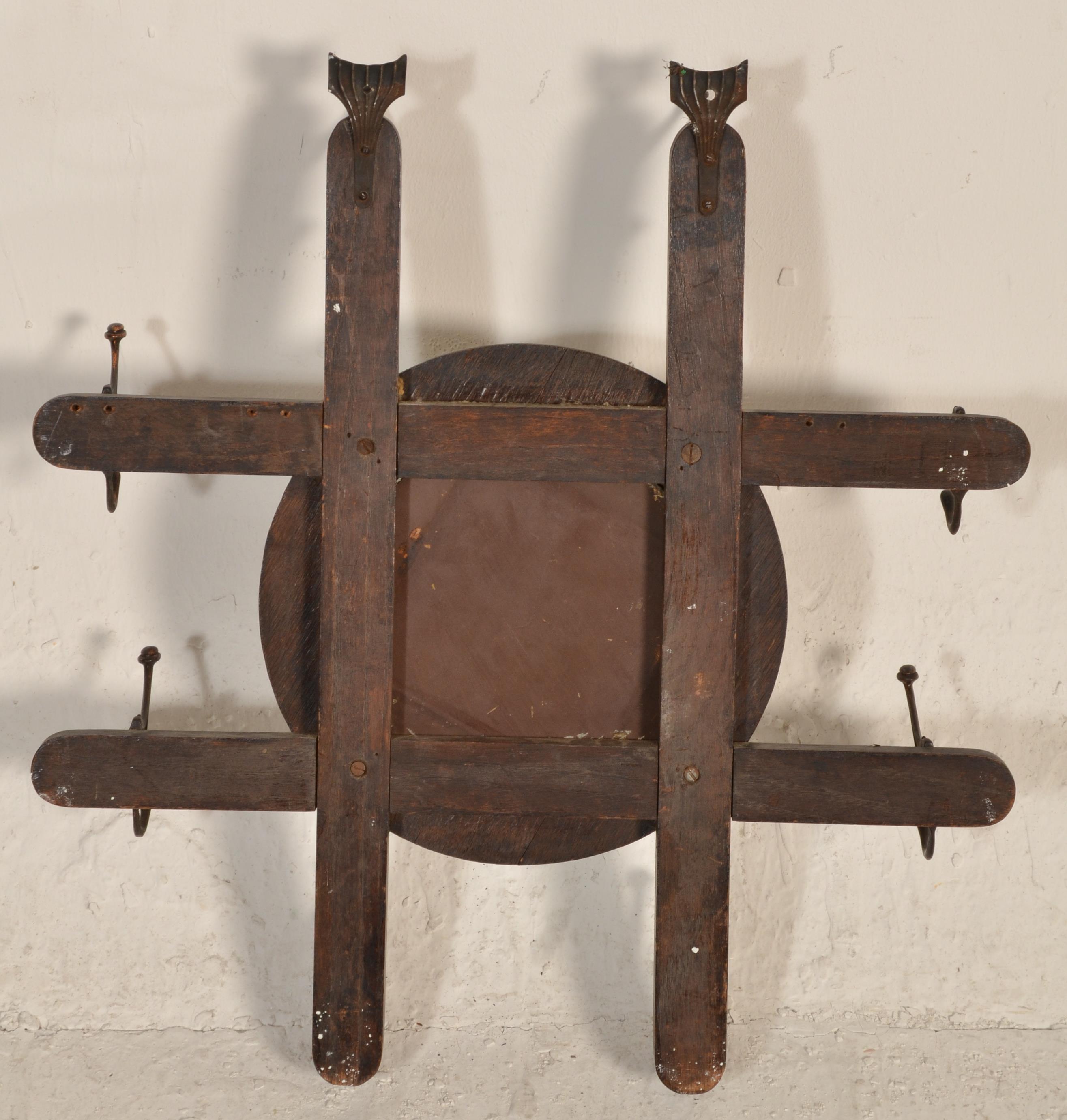 A late 19th century Victorian Arts & Crafts wall mirror coat rack combination. The roundel mirror on - Image 6 of 6