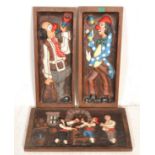 A group of three vintage 20th Century carved wooden wall panels two depicting clowns with painted