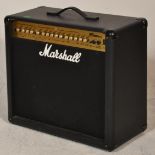 A Marshall MG Series 100DFX Guitar Amplifier in black case with carrying handle atop over dials