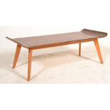 A retro 20th Century bentwood surfboard coffee table having shaped top raised on tapering