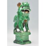 A 19th Century Chinese stoneware ceramic foo / temple dog modelled seated on a plinth base with a