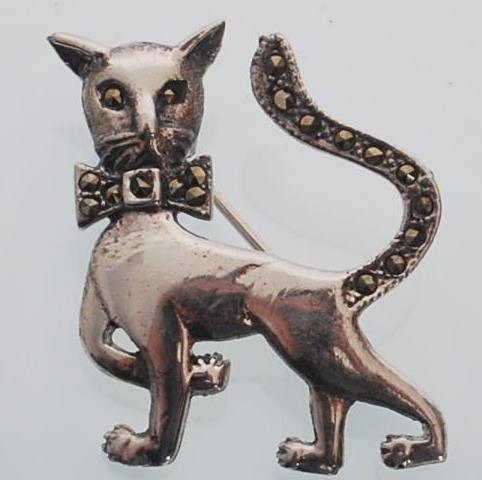 A sterling silver and marcasite brooch in the form of a cat wearing a bow tie. Gross weight 6.1