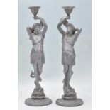 A pair of Victorian 19th century spelter cast figural candlesticks depicting Greek God and Goddess