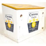 A large free standing Corona Extra beverage cooler fridge having twin lift up doors finished in