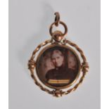 A late 19th Century / early 20th Century Edwardoian 9ct gold mourning pendant of round form having a