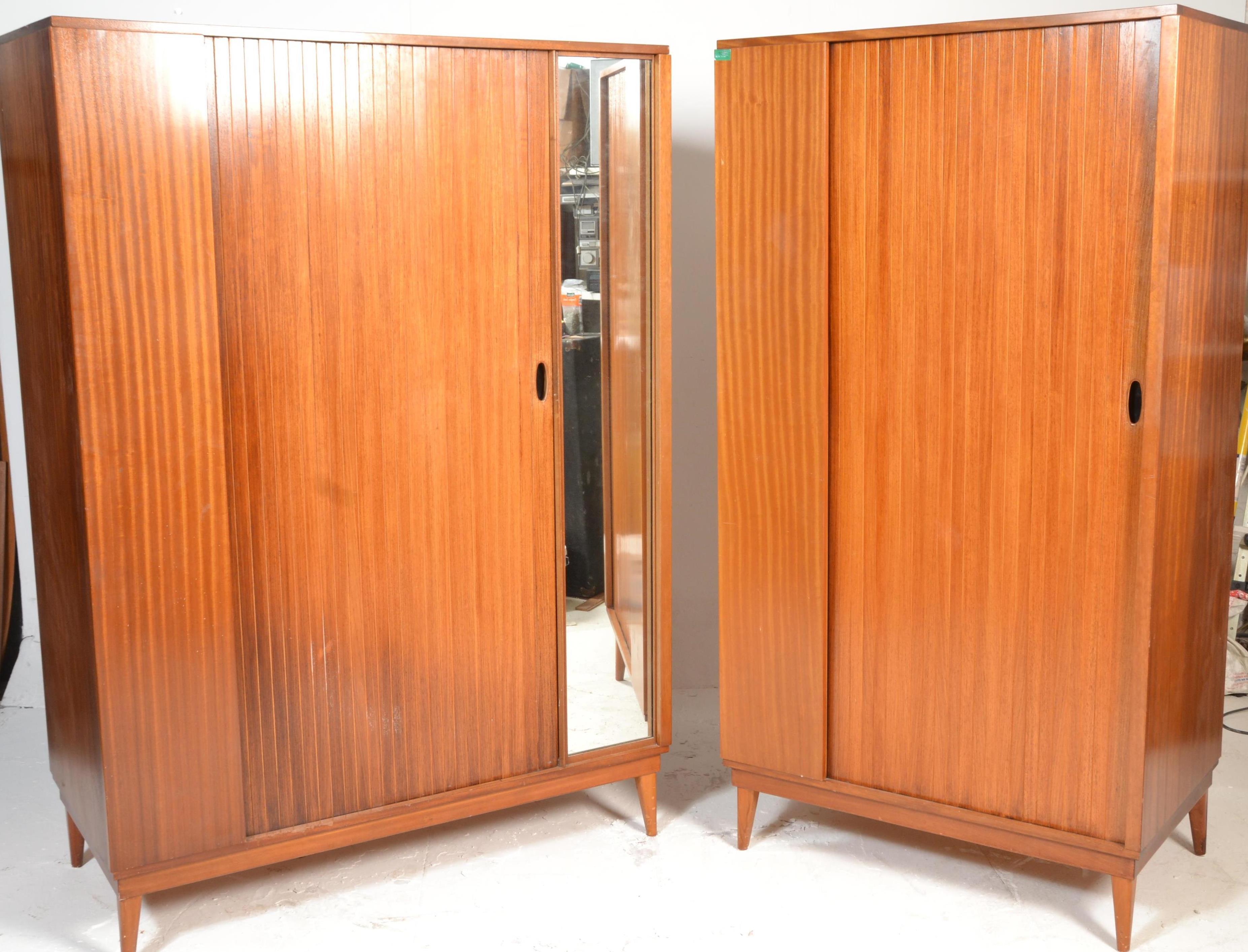 A mid century retro Austinsuite teak wood matching set of ladies and gentlemans wardrobes having