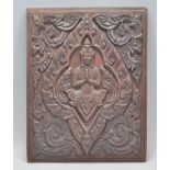 A 19th Century Southeast Asian carved oak wall hanging panel having a central carved God with carved