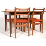 A retro mid 20th century Danish influence teak wood extending dining table and chairs. Raised on 4