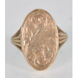An English hallmarked 9ct yellow gold ladies poison ring having an oval engraved hinged cover raised