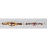 A Victorian 9ct rose gold bar brooch of wirework form set with a central round faceted cut red