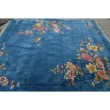 A large 20th century Chinese blue ground floor rug with tassel ends. The blue ground with decorative