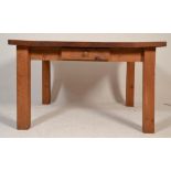 A large contemporary country chunky pine dining table being raised on squared legs with fitted