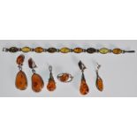 A selection of amber and silver jewellery to include a pair of drop earrings, a spacer bracelet with
