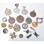 A collection of military medals and enamel badges to include Hallmarked silver tortoiseshell pique