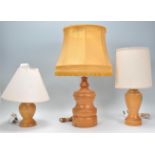 A set of 3 retro mid century teak wood table lamps. Each lamp with turned teak wood baluster